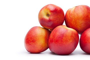 Fototapeta na wymiar group of juicy peaches lying isolated on a white background
