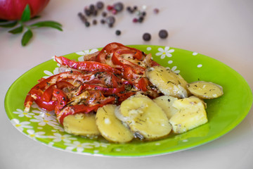 Baked potatoes and vegetables with spices. Stewed potatoes with tomatoes, sweet red pepper and spices.