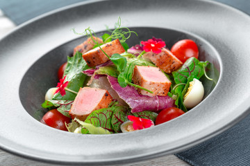 Green salad with cube slices of ham
