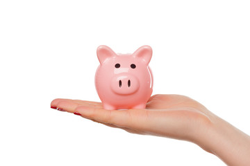Woman holding a pink piggy bank isolated on white