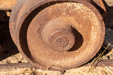 Antique mine cart wheel with deep rusty patina