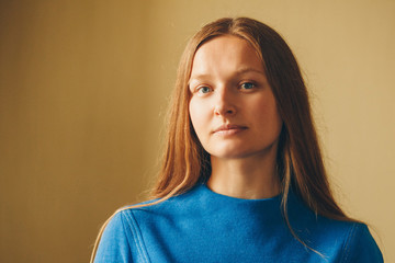 portrait of a beautiful girl with red hair in blue clothes