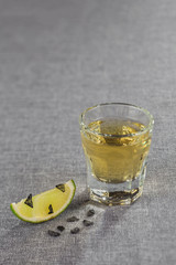 Close-up shot of Golden tequila with a slice of lime and black salt. Diagonal sharpness.