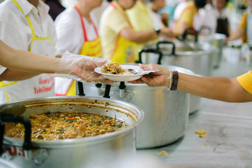 Poor people receive donated food from donors, Demonstrate mutual sharing in today's society : the...