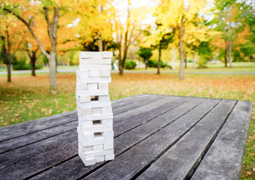 Tower Of Wooden Block Stack Game On The Table In Park Or Backyard, Activities For Family And Friends To Play In Fall And Autumn Season