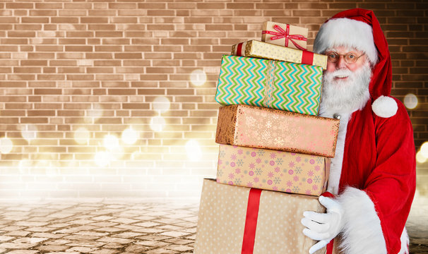 Father Christmas holding a stack of Xmas gifts