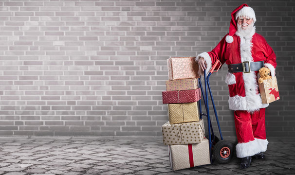 Santa Claus with presents on delivery trolley
