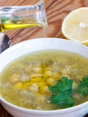 Adding olive oil on chickpea soup
