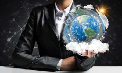 Businessman presenting Earth globe.