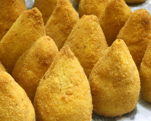 typical Sicilian arancini stuffed with tomatoes and mozzarella