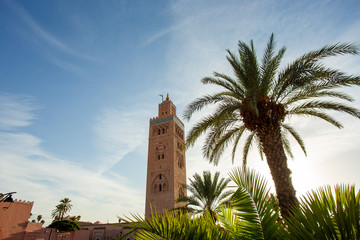Fototapeta premium Koutoubia Mosque minaret (Djemma el Fna tower) in old medina of Marrakech, Morocco. Touristic place in Marrakesh used by local people as square or market place. 