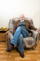 The old man in the armchair at home