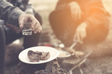 people camping at national park in holiday ; doing breakfast and activity at sunrise ; relaxing in nature 