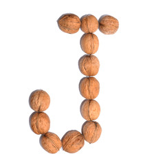 Letter J made with nuts to form a letter of the alphabet. Fruit letters on a white background.