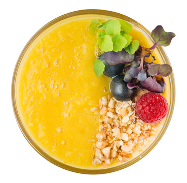 yellow smoothie with orange and mango isolated top view. Glass of milkshake cocktail