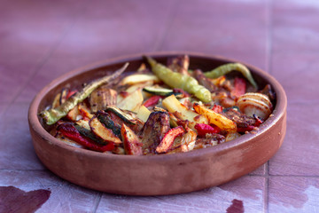 Close-up shoot of onion, pepper, tomato meat meal in the traditional plate