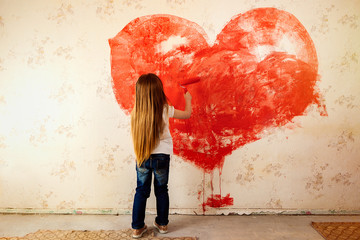 the child painted the wallpaper in the room with red paint. Paint the walls with a roller. The girl painted a heart on the wall. Valentine's Day, a gift to parents.