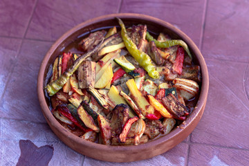 Close-up top view of onion, pepper, tomato meat meal in the traditional plate