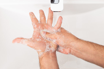 Fototapeta premium Close-up of man cleaning hands.