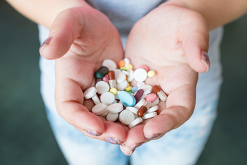 pills capsules in woman hands. pharmacy dosage and drug administration.