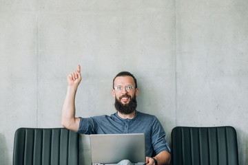 smiling man point up. job candidate and business recruitment concept. empty space for text.