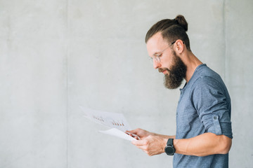 focused man reading documents. information finance report data sheet concept.