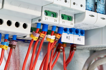 The electrical wires are connected to the relay, controller or device and to the transformer. The cables are marked with numbers. Modern technologies in electrical and technical production.