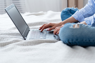 Naklejka premium woman typing on laptop at home. freelance job. remote work.