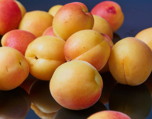 Ripe fresh apricots isolated on black background