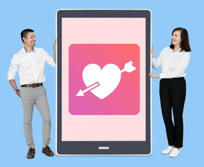 Cheerful couple with an online dating app