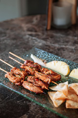 Thai spicy pork barbeque skewers with grill pineapple and Papadum crispy chips