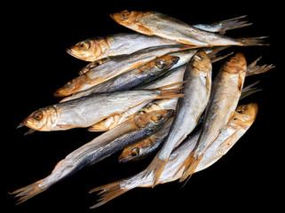 Smoked fish Baltic herring isolated on black background