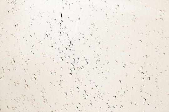 Blured water drops on window in brown tone.
