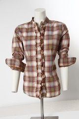 brown gray white plaited blouse shirt on tailor´s dressmaker´s dummy in front of white background