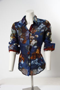 Blue floral blouse shirt on tailor&acute;s dressmaker&acute;s dummy in front of white background