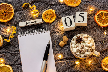 calendar January 5th Cup of cocoa and empty open notepad