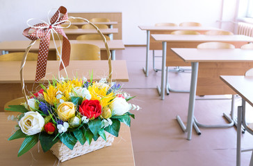Basket with paper flowers on desk
