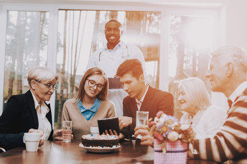 Young and Old People Sit Together. Nursing Home.