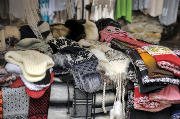 Fototapeta na wymiar Woolen handmade hats on the market with traditional estonian ornament.