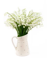 Schilderijen op glas Bouquet of white flowers Lily of the valley (Convallaria majalis) also called: May bells, Our Lady's tears and Mary's tears in a white dotted jug shaped vase isolated on white. © FotoHelin