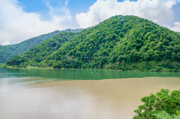view of the confluence of two rivers, mountains