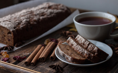 Homemade banana bread with anis star and cinnamon on a dark wooden background