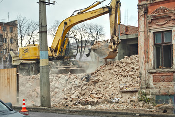 An old, dilapidated building on the background of a new building. Industrial demolition of the house. Concept: replacement of old housing with a new one.