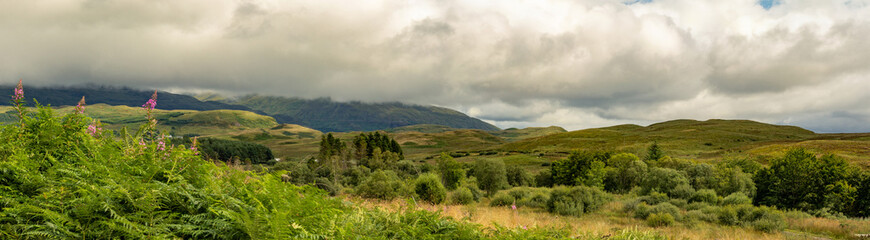 panorama of glen land with blue sky and clouds