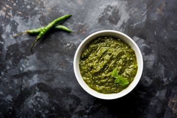 Healthy Indian Green Chutney or Sauce Made using Coriander, Mint And Spices. isolated over moody background. Selective focus