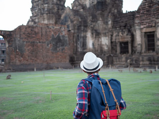 Senior man Asian with backpack are walking at Phra Prang Sam Yot. Ancient and historical attractions and one of the most important archaeology of Lopburi province thailand. Travel, Tourist Concept