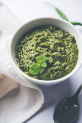 Healthy Indian Green Chutney or Sauce Made using Coriander, Mint And Spices. isolated over moody background. Selective focus