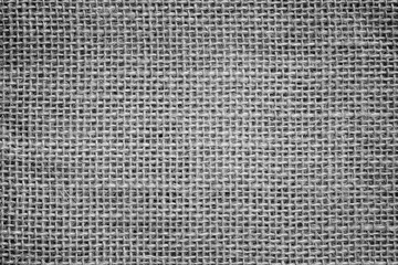 Close-up of a burlap jute canvas full frame background with vignetting in black and white.