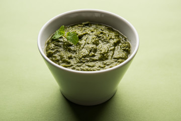 Healthy Indian Green Chutney or Sauce Made using Coriander, Mint And Spices. isolated over moody background. Selective focus