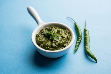 Healthy Indian Green Chutney or Sauce Made using Coriander, Mint And Spices. isolated over moody background. Selective focus